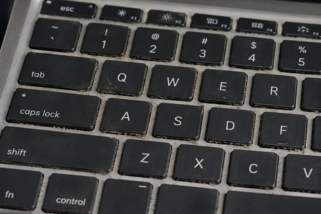 Close-up of worn laptop keyboard keys